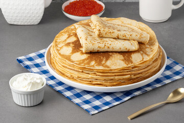 Freshly baked pancakes with sour cream and red caviar