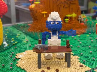 Fototapeta premium Lego blue smurf figure behind table