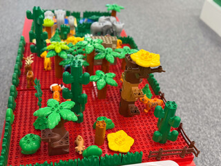 Fototapeta premium Toy jungle playset on red baseplate