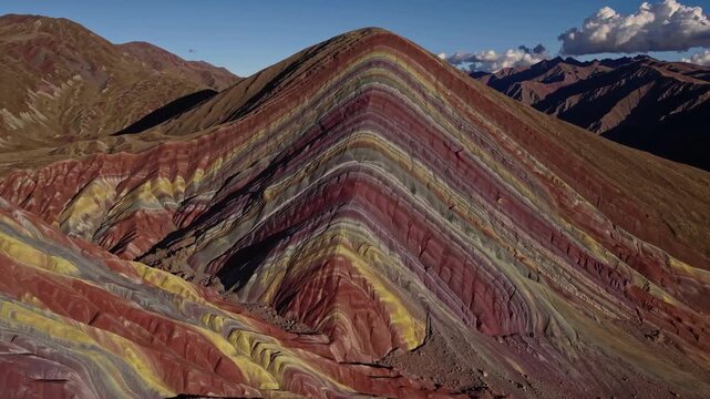 Colorful Mountain Layers. Vivid Multicolored Mountain Strata Reveal Ancient Geological History. Aerial Perspective Highlights Vibrant Sedimentary Layers And Distant Mountain Peaks
