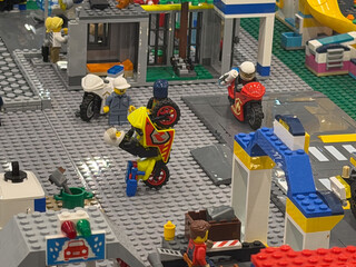 Fototapeta premium Lego city street with motorcycle stunt and police figures