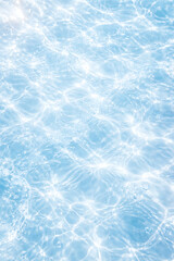 Obraz premium Clean blue water surface with bright sunlight reflections and shimmering waves serves as a beautiful natural background for an environmental message about world water day