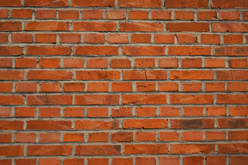Fototapeta premium A close-up view of a red brick wall texture background