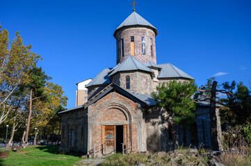 Fototapeta premium Title Historic Church in Tbilisi on Cobblestone Street with Relief and Lighting