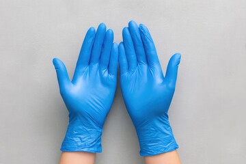 Obraz premium Hands Donning Blue Latex Gloves