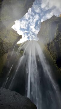low angle view of gljufrabui waterfall inside a cave in iceland