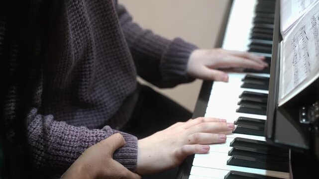 The girl who gives lessons in a piano. Close up. High quality video