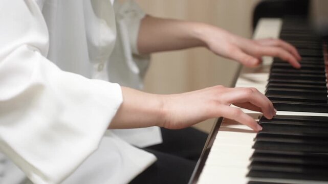 Young kid playing piano, closeup. Music school lesson