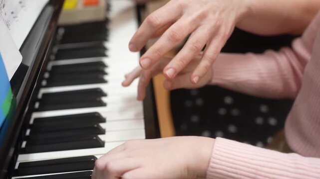 The girl who gives lessons in a piano. Close up. High quality video