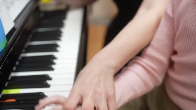 The girl who gives lessons in a piano. Close up. High quality video