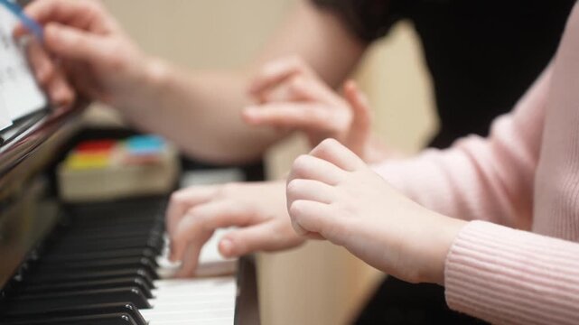 The girl who gives lessons in a piano. Close up. High quality video