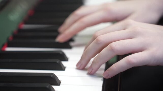 Young kid playing piano, closeup. Music school lesson