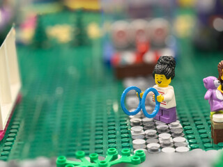 Naklejka premium Lego minifigure playing with blue rings