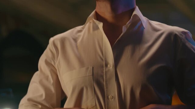 Closeup stylish business man rolling up sleeves adjusting collar formal shirt in night evening work relaxing unrecognizable unknown businessman fashionable leader male guy wearing style luxury clothes
