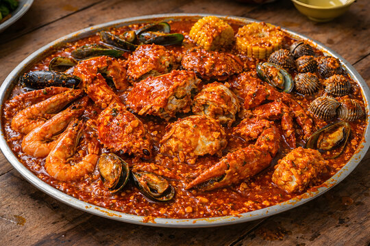 Indonesian Kepiting Saus Padang with Mixed Seafood on Rustic Table