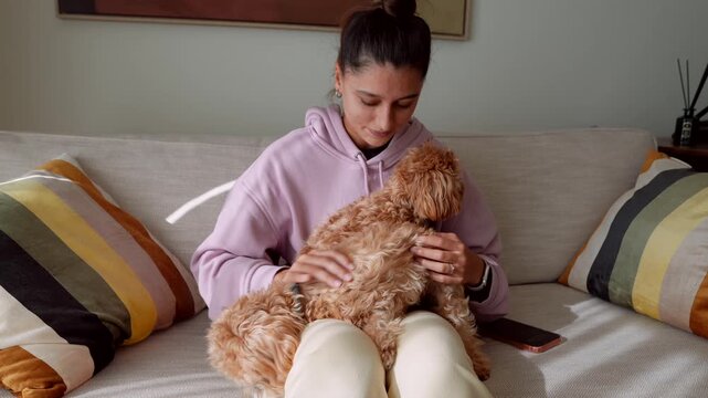 Calm woman lovingly embraces drowsy puppy during peaceful afternoon