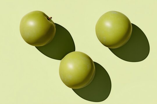 Green greengage plums sit on a light green surface casting round shadows in midday light