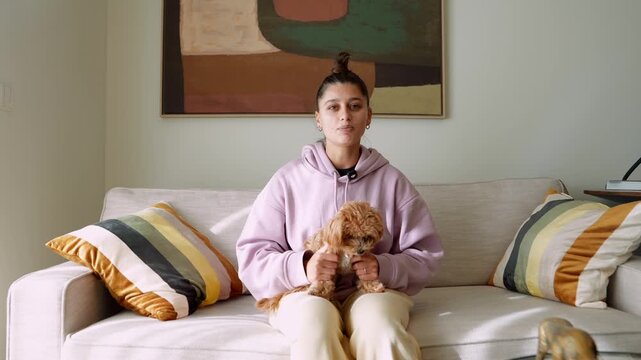 Gentle moment where woman relaxes with her pet on comfortable furniture