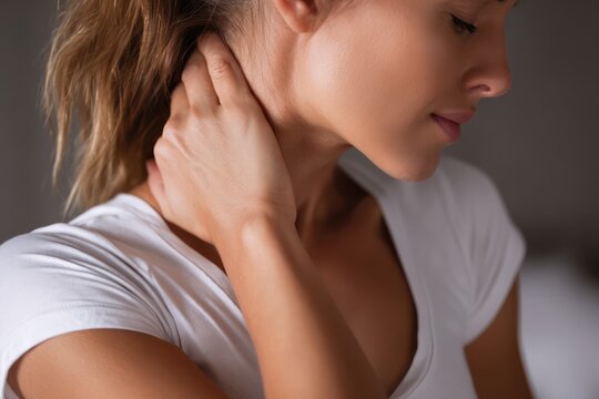 Woman massaging painful neck muscle tension