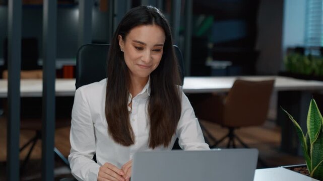 Carefree Caucasian smiling business woman working laptop looking in monitor at office table businesswoman smiling look in computer workplace smile female girl satisfied with online task achievement