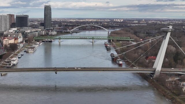 Aerial view of SNP Bridge over the Danube River with its iconic UFO restaurant contrasting against the cityscape, Bratislava, Bratislava Region, Slovakia.