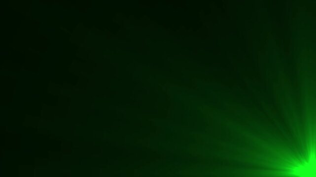 Vibrant green light rays bursting from the lower right corner against a dark black background with a noticeable glow and atmospheric diffusion creating a vivid and energetic visual effect for