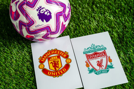 Manchester United vs. Liverpool Premier League football game, official match ball on lush green pitch, wallpaper with copy space.