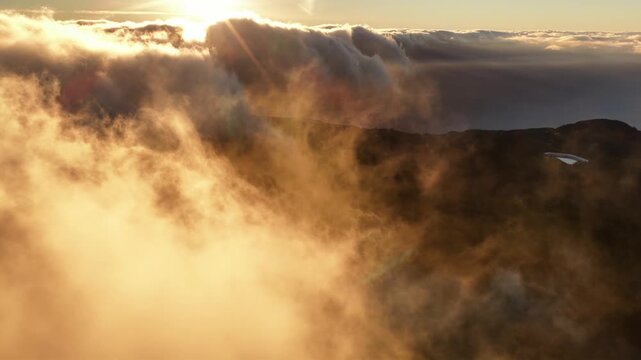 Spectacular Madeira sunset above flowing cloud layers