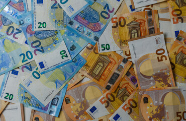 Obraz premium Closeup of Euro bills arranged on table for finance concept