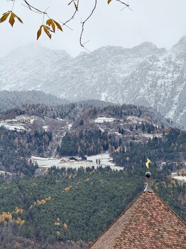 Panorama mountain landscape in Naturns in South Tyrol in autumn. In the background, the snow-covered mountains, shrouded in dense fog, no people.