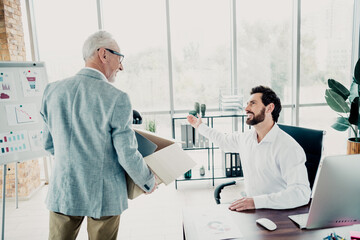 Obraz premium Business meeting in a modern office as a colleague delivers a box and discusses a project with a manager