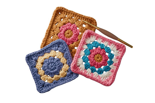 Three vibrantly colored crochet granny squares with a hook, showcasing handmade craft and needlework art