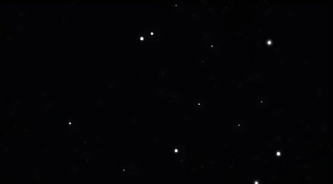 Deep space view with many faint stars scattered across a black background
