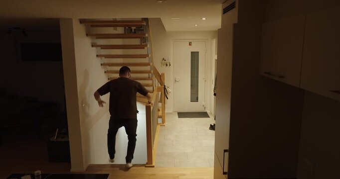 Dramatic indoor scene of civilians rushing downstairs to a basement shelter during a rocket alert, illustrating emergency response, conflict tension, and civilian safety measures.