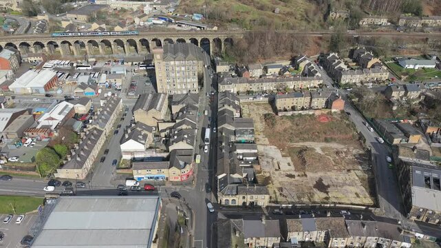 Aerial Drone footage Pan of Milnsbridge, Huddersfield, Featuring Historic Industrial Architecture and Railway Infrastructure.
