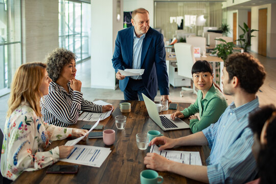 Business team meeting with manager in modern open office