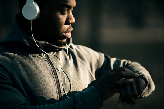Man checking smartwatch while training outdoors