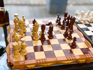 Naklejka premium Lego-style chess set on checkered board