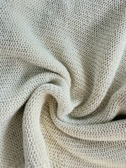 Sweater or scarf fabric texture large knitting. Knitted jersey background with a relief pattern. Wool hand- machine, handmade. 