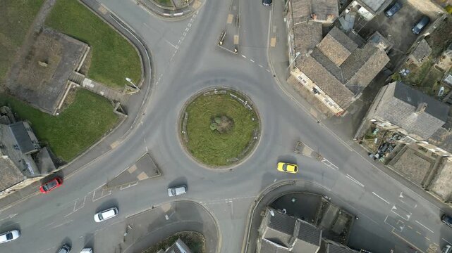 ​Timelapse Aerial top-down view of traffic circulating a busy urban roundabout in Huddersfield, West Yorkshire. 