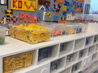 Naklejka premium Organized lego bins on white shelving