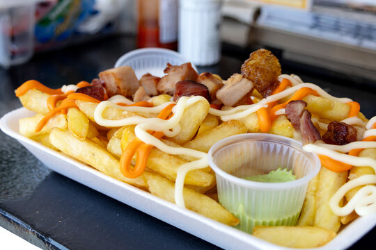Crispy golden French fries topped with savory fried pork belly.