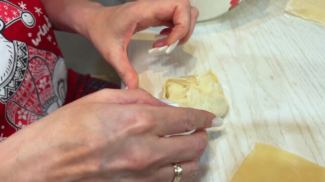 Close-up of woman hands making festive manti dumplings for Eid