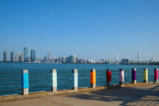 Haikou Coastal Promenade with Colorful Bollards and Urban Skyline