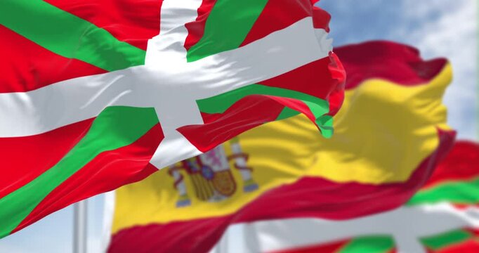 Basque Country and Spanish flags waving in the wind