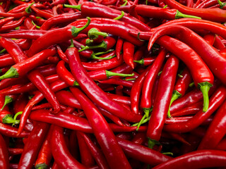 Fresh red chili peppers pile texture background, hot red chili peppers close up spicy vegetable...
