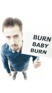 Man holding sign Burn Baby Burn on white background