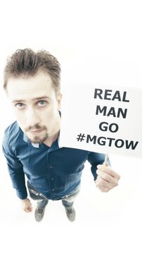Man holding sign Real Man Go #MGTOW top down view on white background