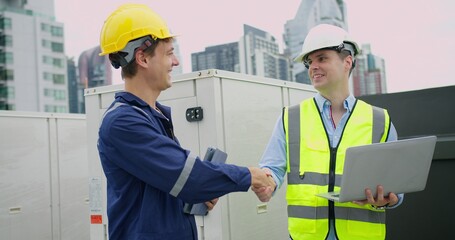 Professional engineer is inspecting industrial machinery valves in a modern plant, focusing on...