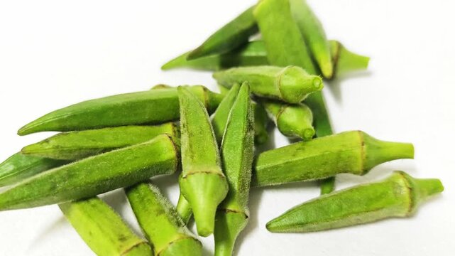 Fresh green okra or lady's finger pods isolated on white background.